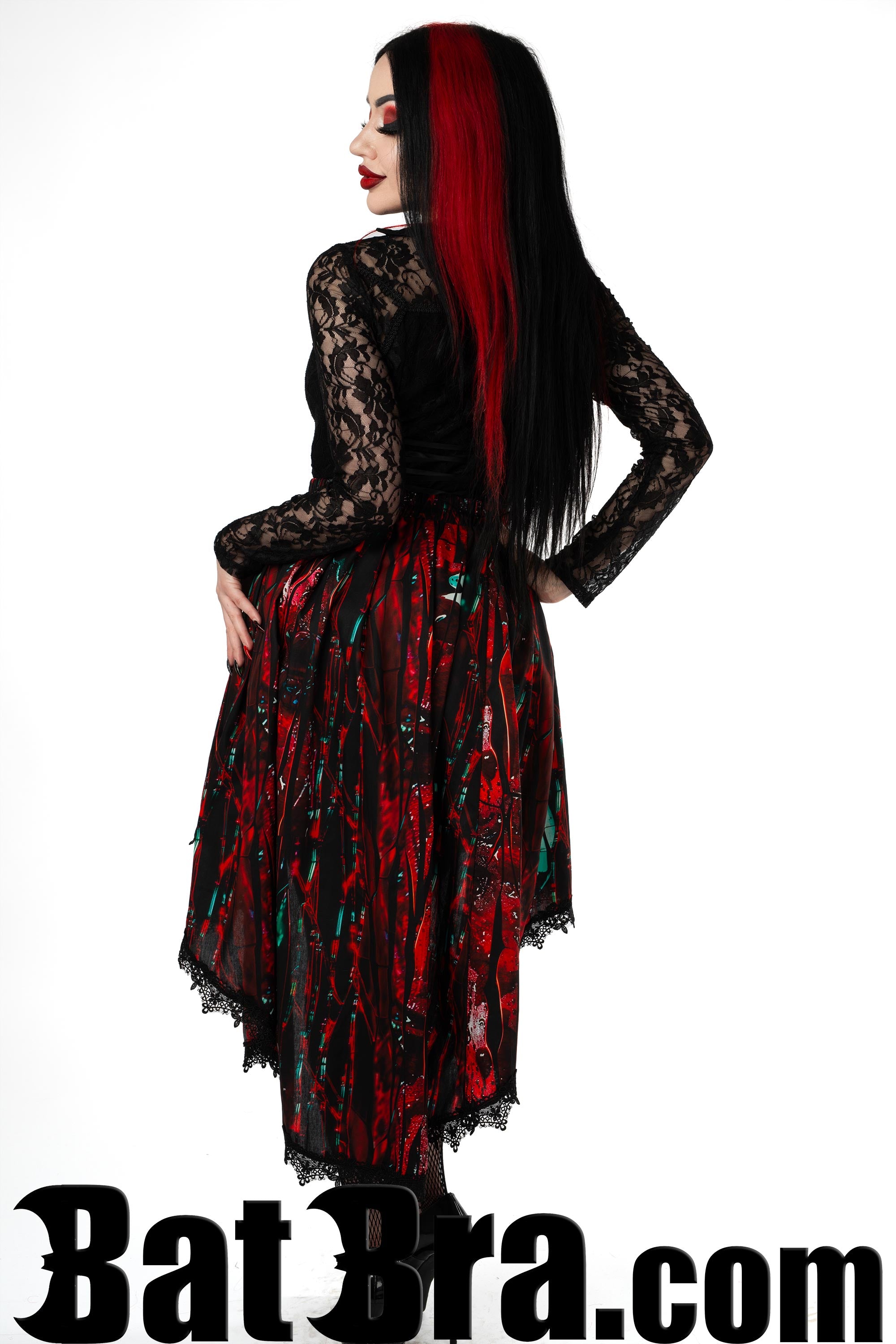 Back view of women's red blood print skirt in asymmetrical style showing longer back of skirt and black lace trim