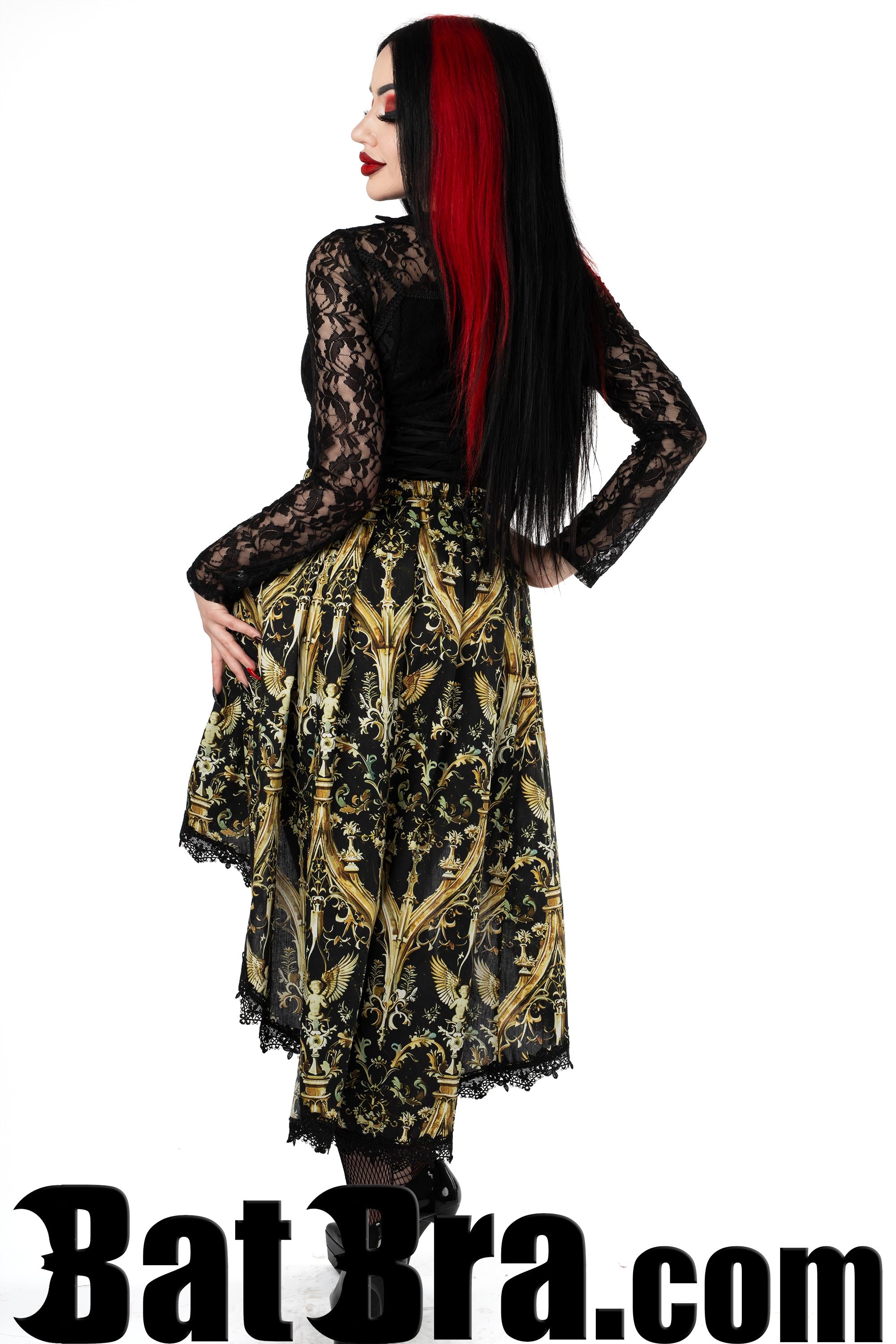 Back view of black and gold cherub print skirt showing longer back elasticated waist and lace trim hemline