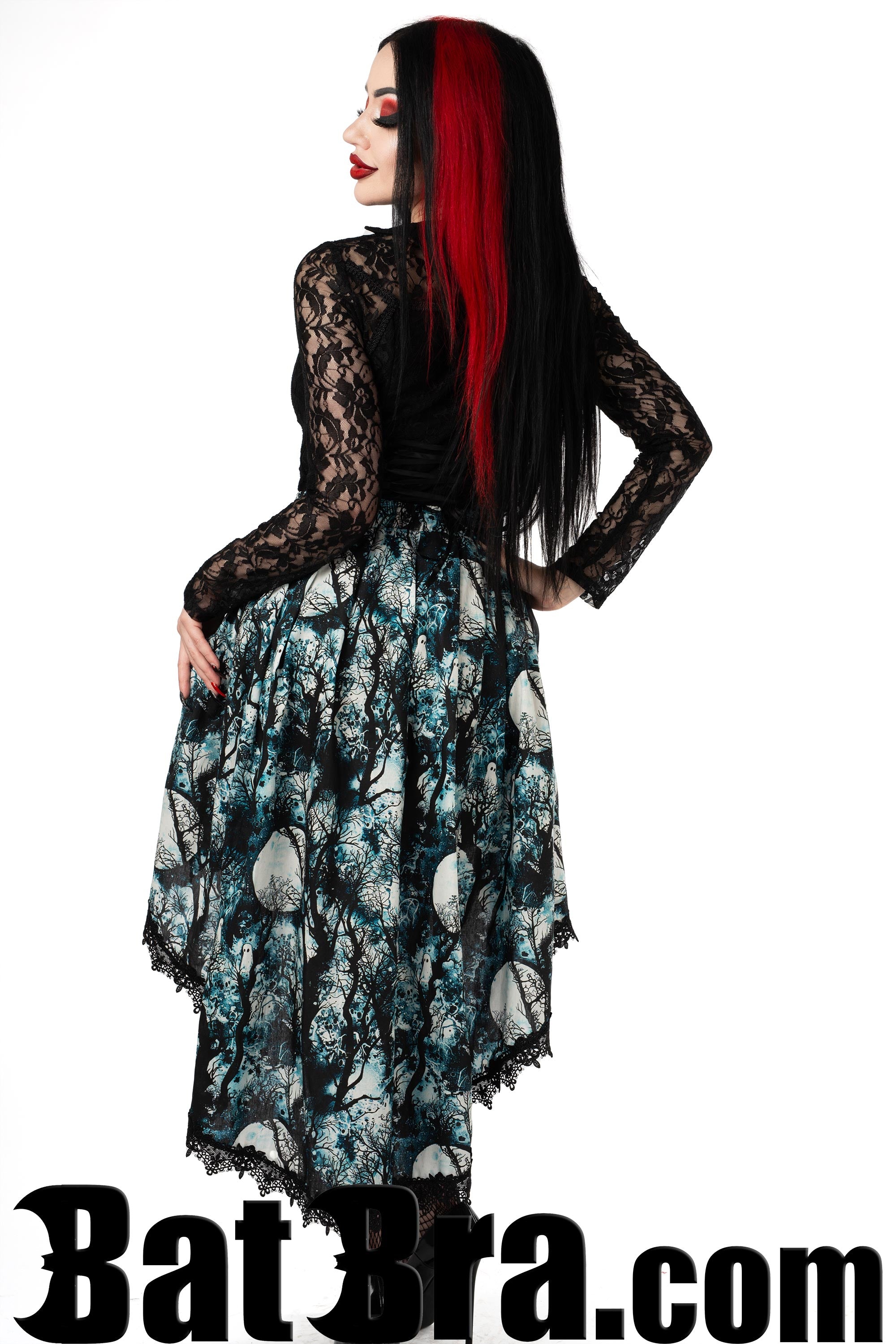 Back view of asymmetrical women's skirt with full moon and forest print in pale blue colour showing longer back of skirt and black lace trim on hem