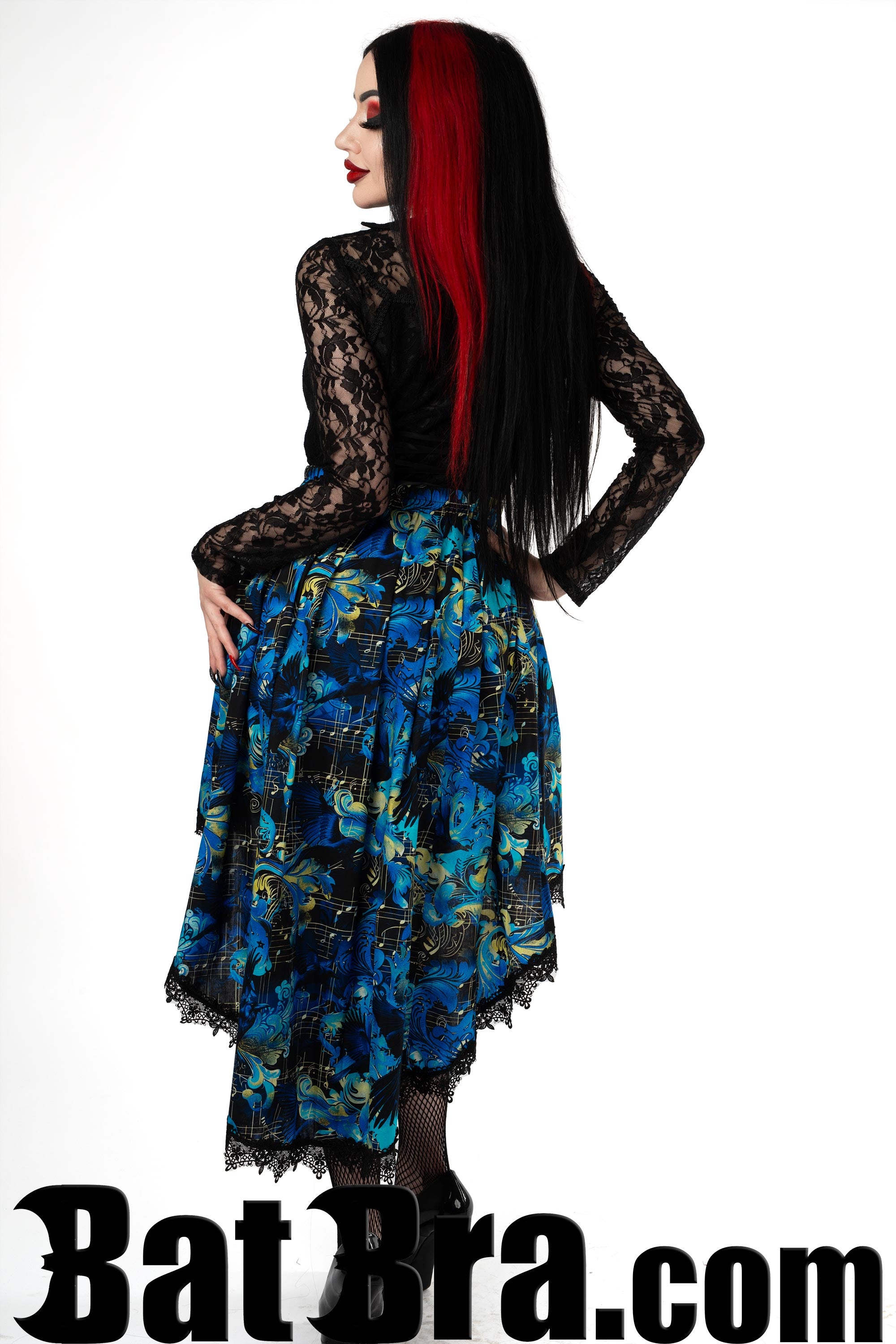 Back view of women's asymmetrical skirt made with a blue printed raven music design showing longer back and lace trim hem